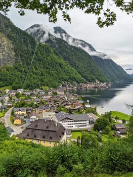 Hallstatt Austria city at lake and mountains panorama with cloudy sky