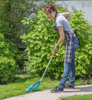 Happy female working in garden in summer