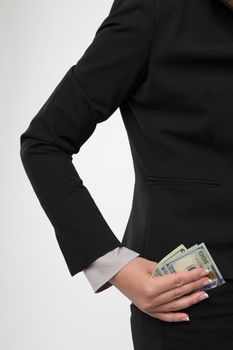 Businesswoman is putting money in her pocket