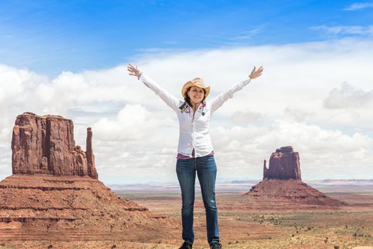 Young woman wearing straw hat in Monumet Valley