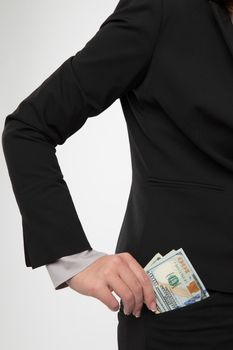 Businesswoman is putting money in her pocket