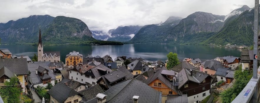 Hallstatt Austria city at lake and mountains panorama with cloudy sky