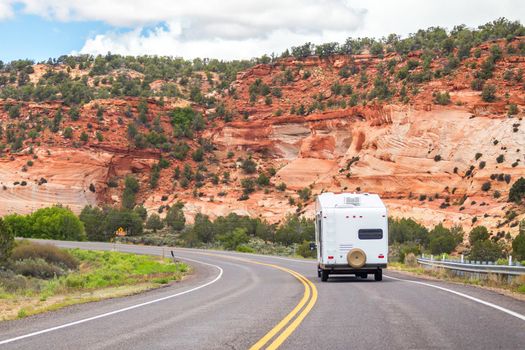 White Colour Motorhome Car Goes On Road On Background Of Mountains