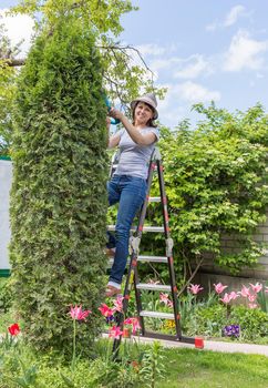 Happy female working in garden in summer