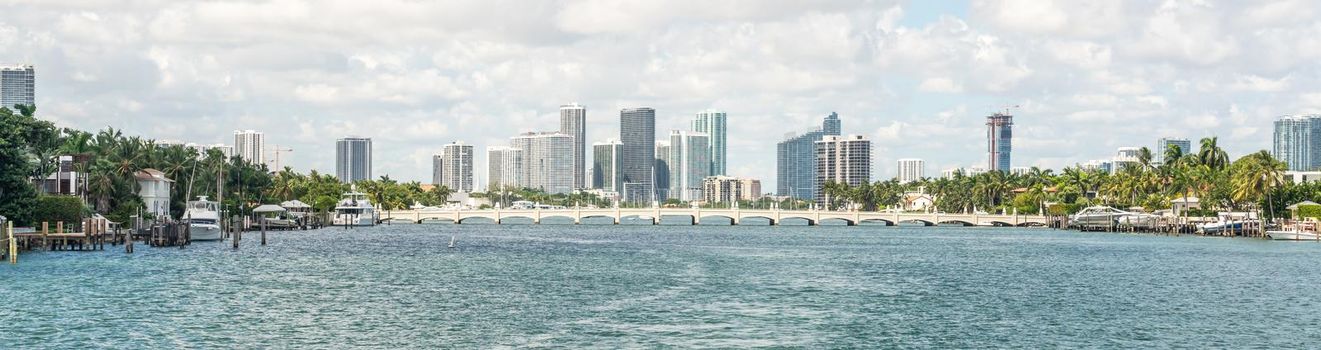 Miami skyline with skyscrapers and bridge over the sea