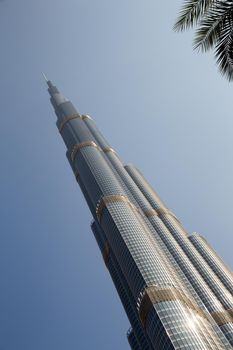 DUBAI, UNITED ARAB EMIRATES – JANUARY 20: Tower Burj Khalifa vanishing in blue sky on January 20, 2014 in Dubai. It is the tallest structure in world since 2010, 829.8 meters and one of the most visited tourist attractions in the world.