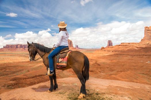 Cowboy woman on a horse in Monument Valley Navajo Tribal Park in USA