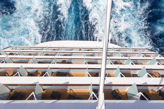 Balconies on a Cruise ship, decks with wake or trail on ocean surface