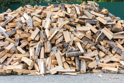 firewood background - chopped firewood on a stack