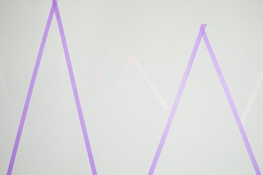 White wall with masking tape to paint with different colors