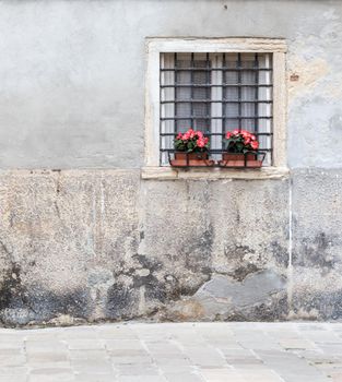 Window with bars in the old house of the city of Venice Italy