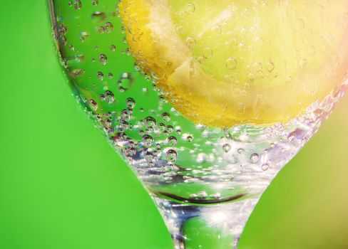 Glass of sparkling mineral water with lemon