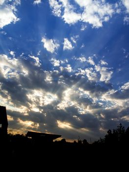 White and grey fluffy clouds in the blue sky with morning light from the sunrise