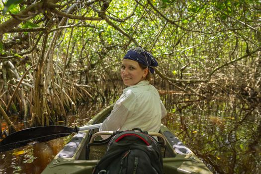 Tourist kayaking in mangrove forest in Everglades, Florida, USA