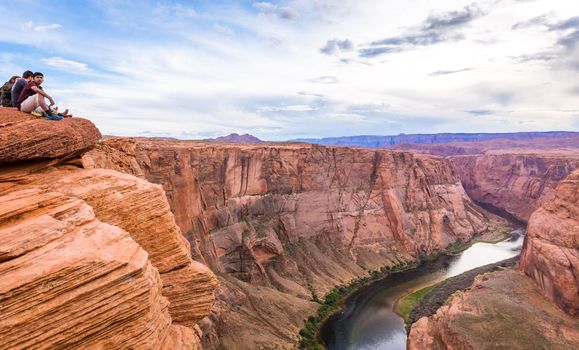 PAGE, ARIZONA - MAY 25: Hikers at Horseshoe Bend on May 25, 2015 in Page AZ,USA. Thousands of people from all over the world visit this unique place every year.