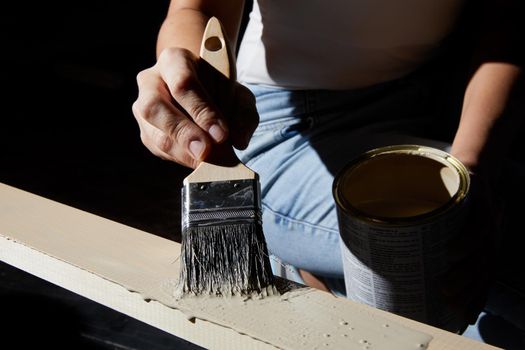 Hand painting surface of natural wood plank into white color
