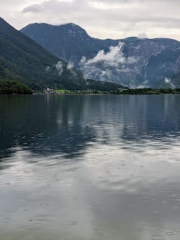 Alpine lake Hallstatter See during rain, central europe travel destination