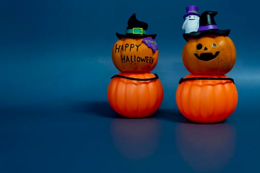 Halloween glitter pumpkin jack o lantern on a dark blue background. Halloween concept backdrop