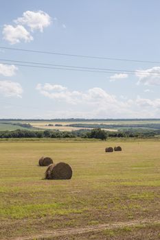 Beautiful landscape with straw bales in summer