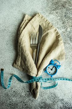 Lose weight concept with cutlery set with measuring tape