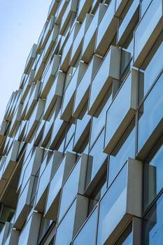 Textured background with metal and glass building wall