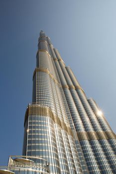 DUBAI, UNITED ARAB EMIRATES – JANUARY 20: Tower Burj Khalifa vanishing in blue sky on January 20, 2014 in Dubai. It is the tallest structure in world since 2010, 829.8 meters and one of the most visited tourist attractions in the world.