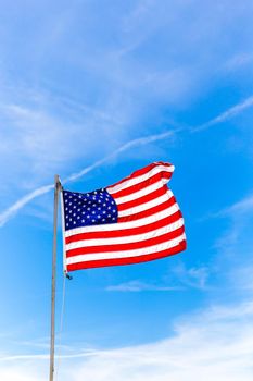 Close up Flag of United States of America waving in the wind with sky background