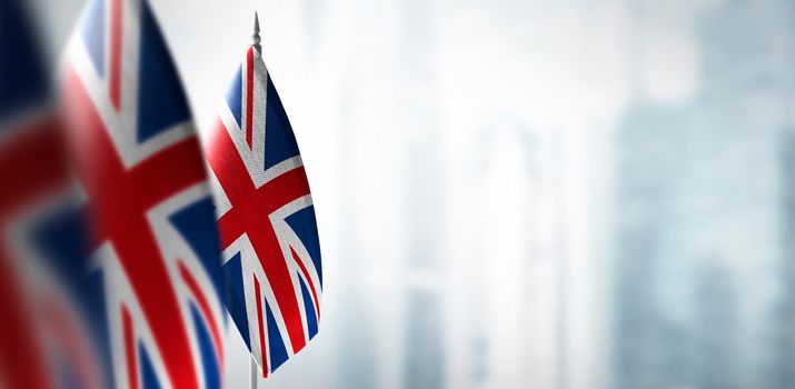 Small flags of United Kingdom on a blurry background of the city.