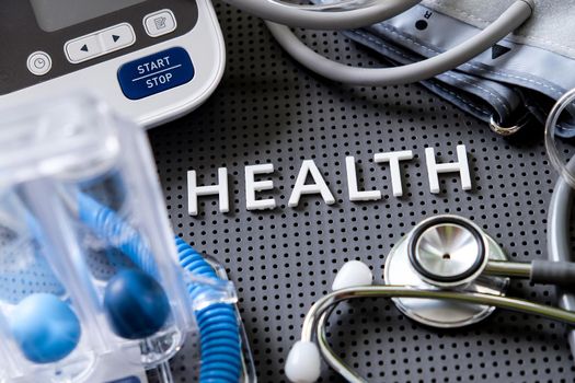 Concept image of Health background, health letters and medical equipment on gray background.