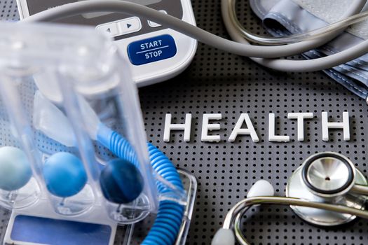 Concept image of Health background, health letters and medical equipment on gray background.