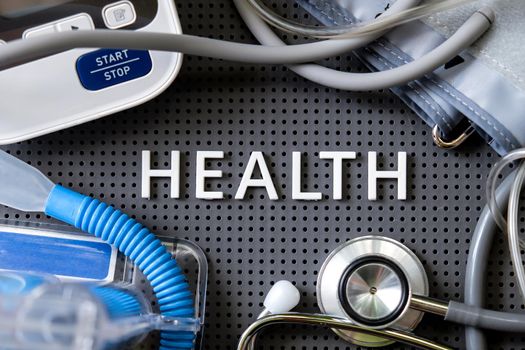 Concept image of Health background, health letters and medical equipment on gray background.