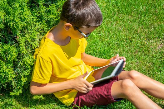 Cute boy playing internet games with tablet