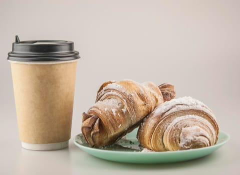 Two fresh croissants in plate on white background. Breakfast