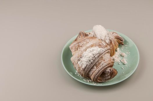 Two fresh croissants in plate on white background. Breakfast