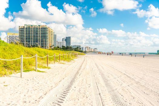 Wide South Beach in Miami Florida with grass and buildings