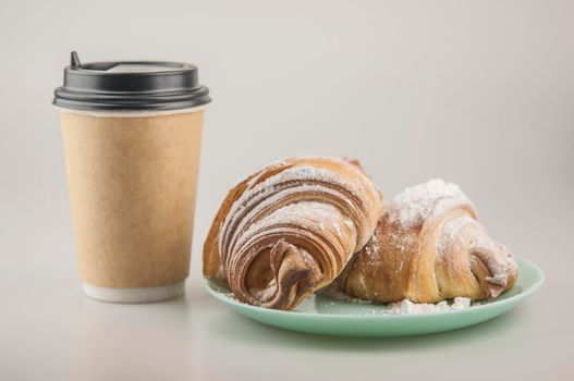 Two fresh croissants in plate on white background. Breakfast