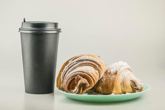 Two fresh croissants in plate on white background. Breakfast