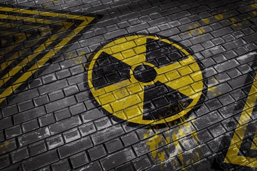 3D illustration depicting a brick wall with a radioactive hazard sign and yellow-black lines