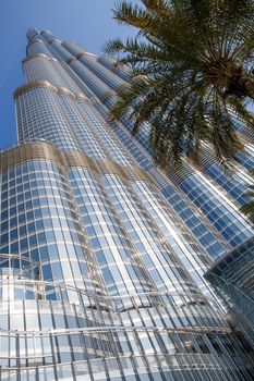 DUBAI, UNITED ARAB EMIRATES – JANUARY 20: Tower Burj Khalifa vanishing in blue sky on January 20, 2014 in Dubai. It is the tallest structure in world since 2010, 829.8 meters and one of the most visited tourist attractions in the world.