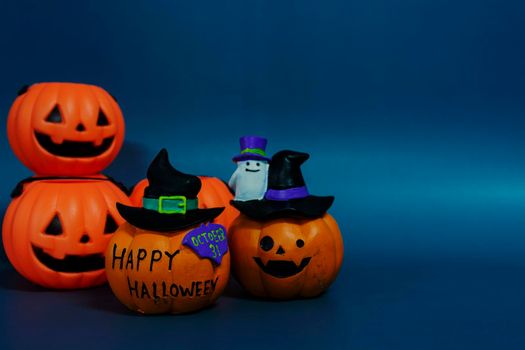 Jack o lantern pumpkin on a dark blue background. Halloween concept backdrop