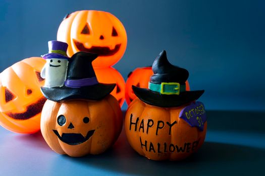 Jack o lantern pumpkin on a blue background. Halloween concept backdrop