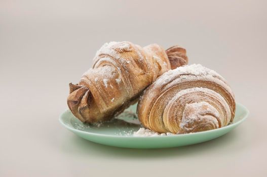 Two fresh croissants in plate on white background. Breakfast