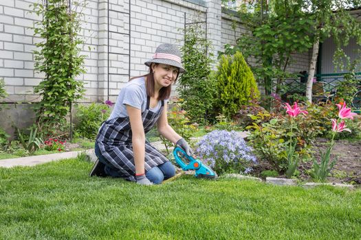 Happy female working in garden in summer