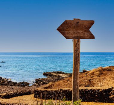 Od wooden road signs indicating the direction for the beach, Linosa