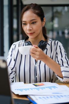 Business woman speaking on video call on online briefing with laptop computer at her office.