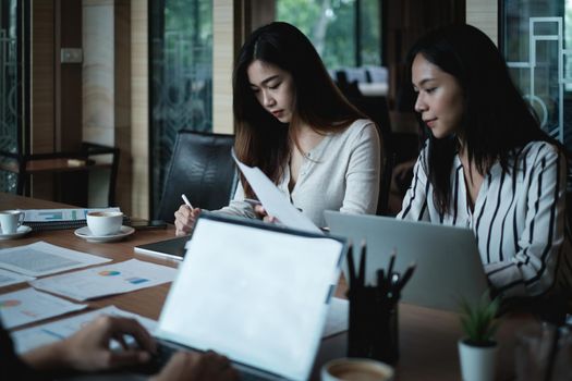 Analytics intelligence concept. Group of business people discuss current financial and economic on laptop for investment at the meeting