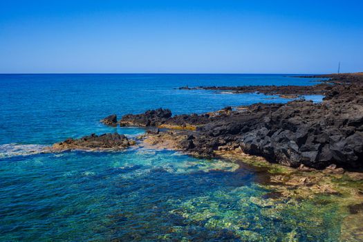 View of the scenic lava rock cliff in the Linosa island. Sicily