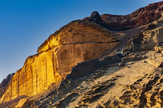 View of the Linosa volcano called Monte Nero in the beach of Cala Pozzolana di Ponente, Sicily