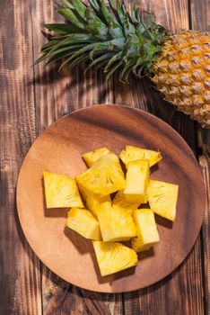 Tropical fruit concept. Cutted pineapple on the old wooden background. 