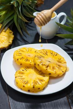 Grilled pineapple on a black wooden table